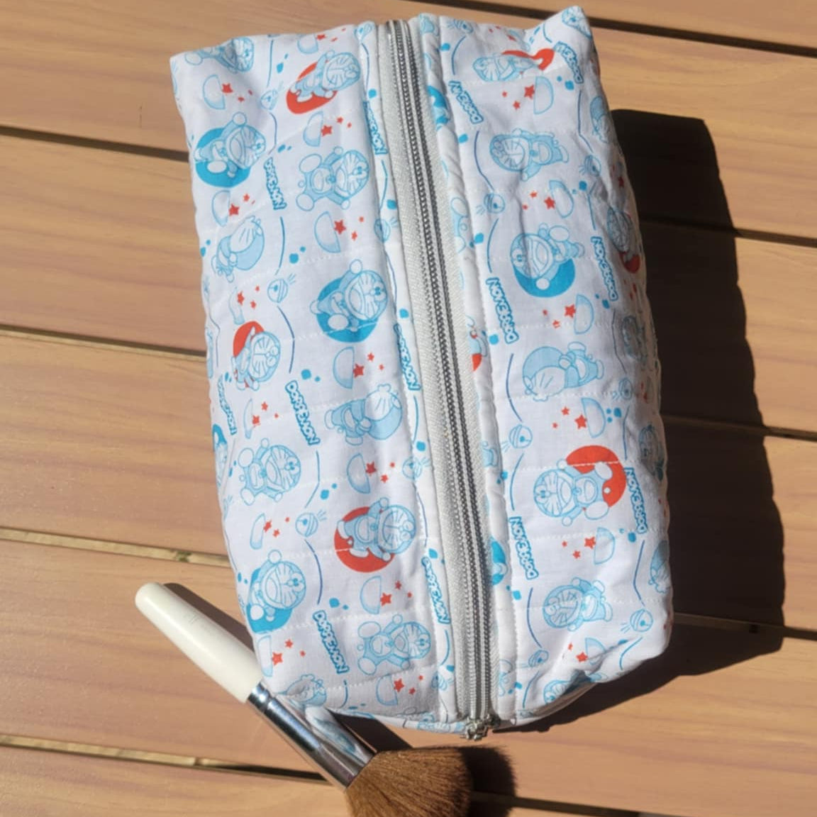Makeup bag with a pattern of cartoon characters on a wooden surface