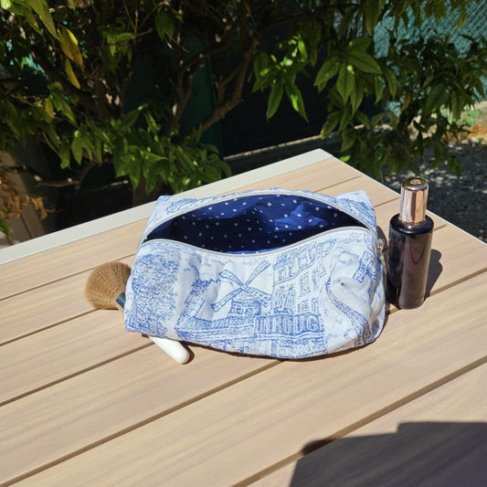 Cosmetic bag with blue interior on a wooden surface outdoors