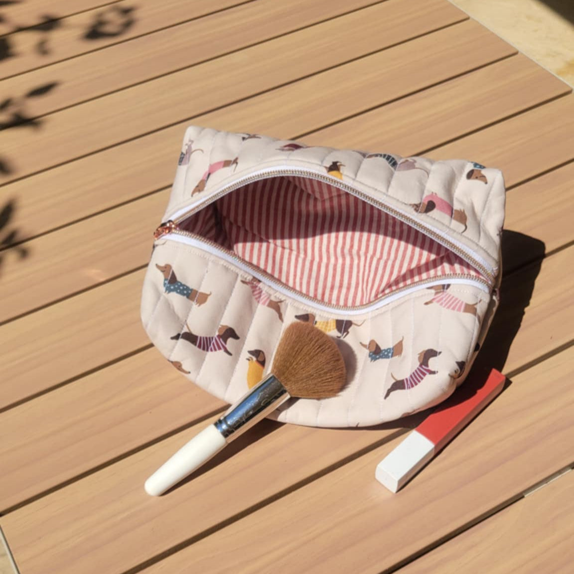 Waterproof dachshund cosmetic bag with red striped lining