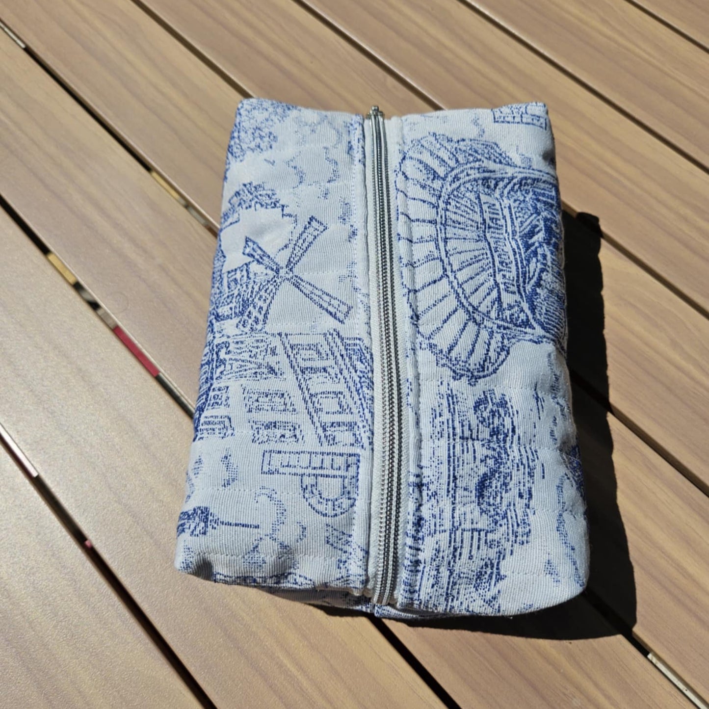 Folded fabric with blue patterns on a wooden surface