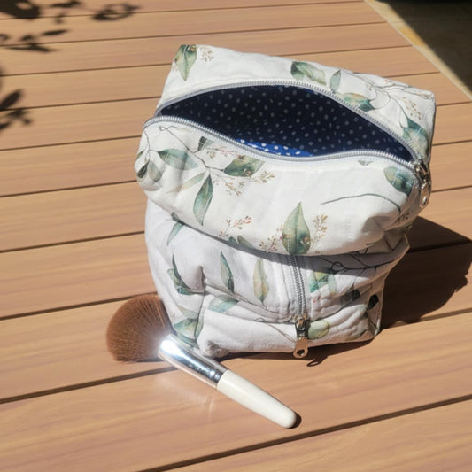 Floral-patterned bag with a blue interior on a wooden surface