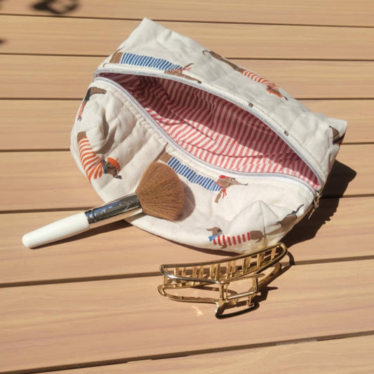 Small pouch with a wooden spoon and pen on a wooden surface