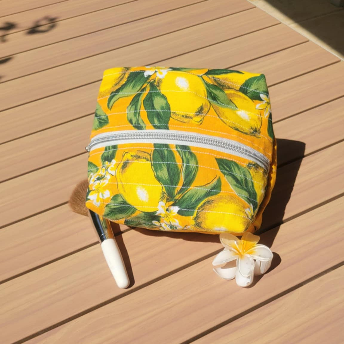 Yellow bag with lemon pattern on a wooden table
